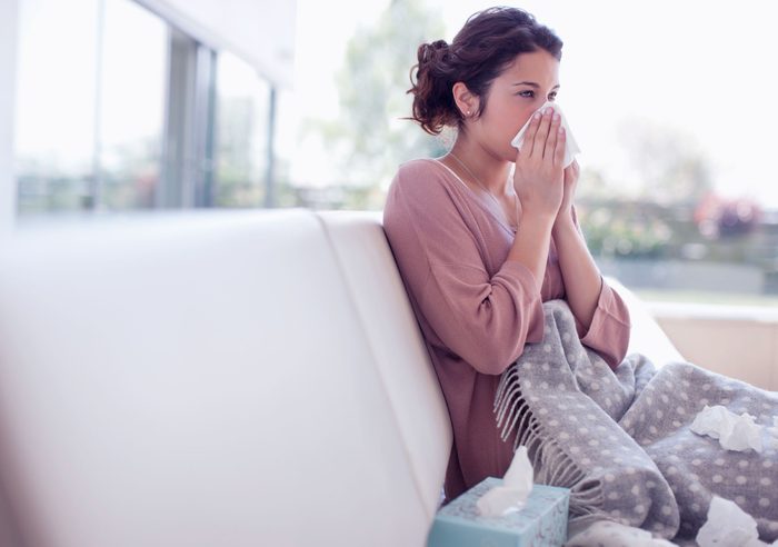 woman blowing her nose
