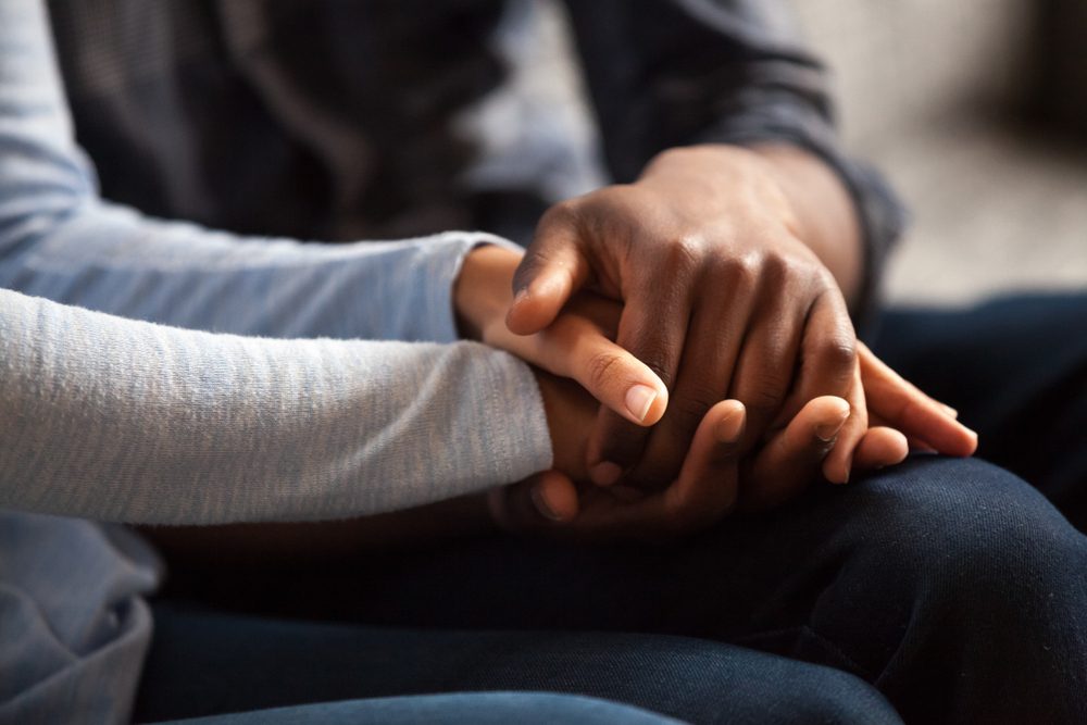 close up of couple holding hands
